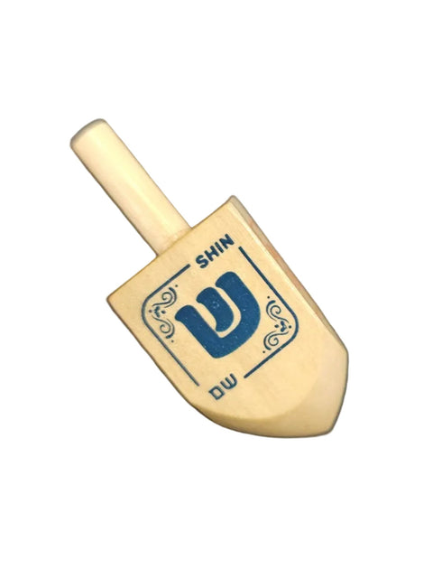 Wooden dreidel with the hebrew letter shin with a white background